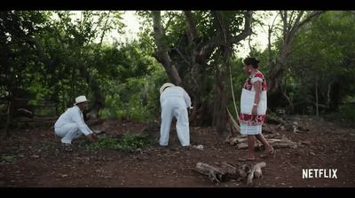 a group of men standing around a forest