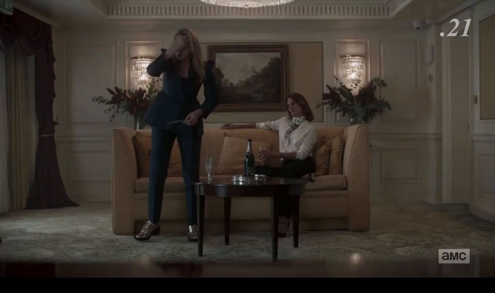 a woman standing in a living room next to a man