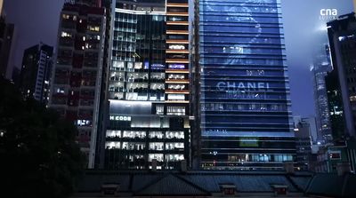 a very tall building in the middle of a city at night