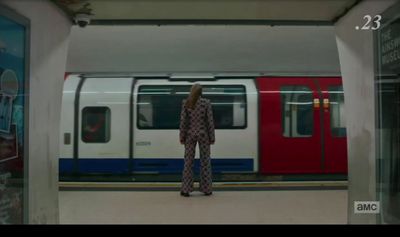 a woman standing in front of a train at a train station