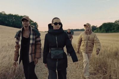 a group of people walking through a field