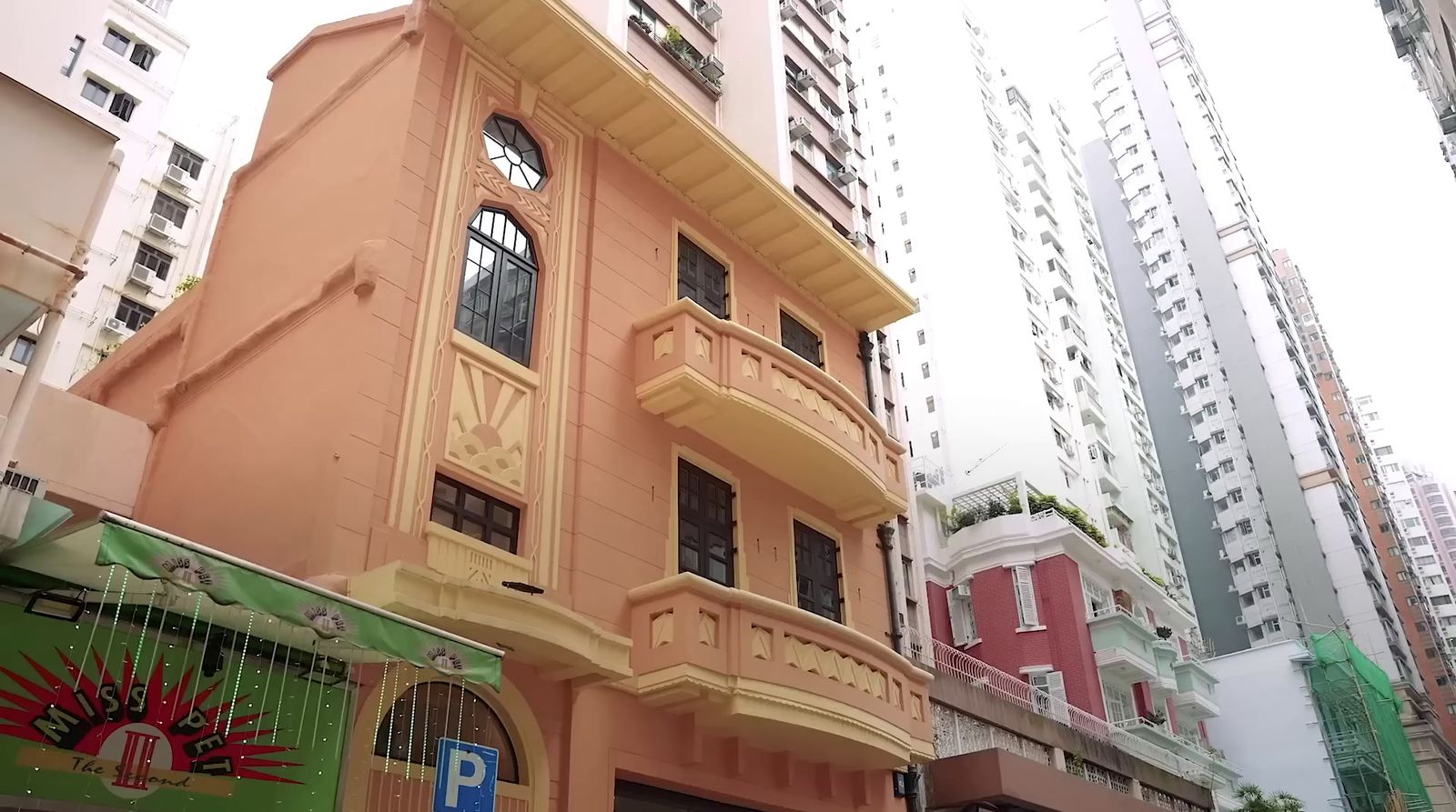 a tall building with balconies on the top of it