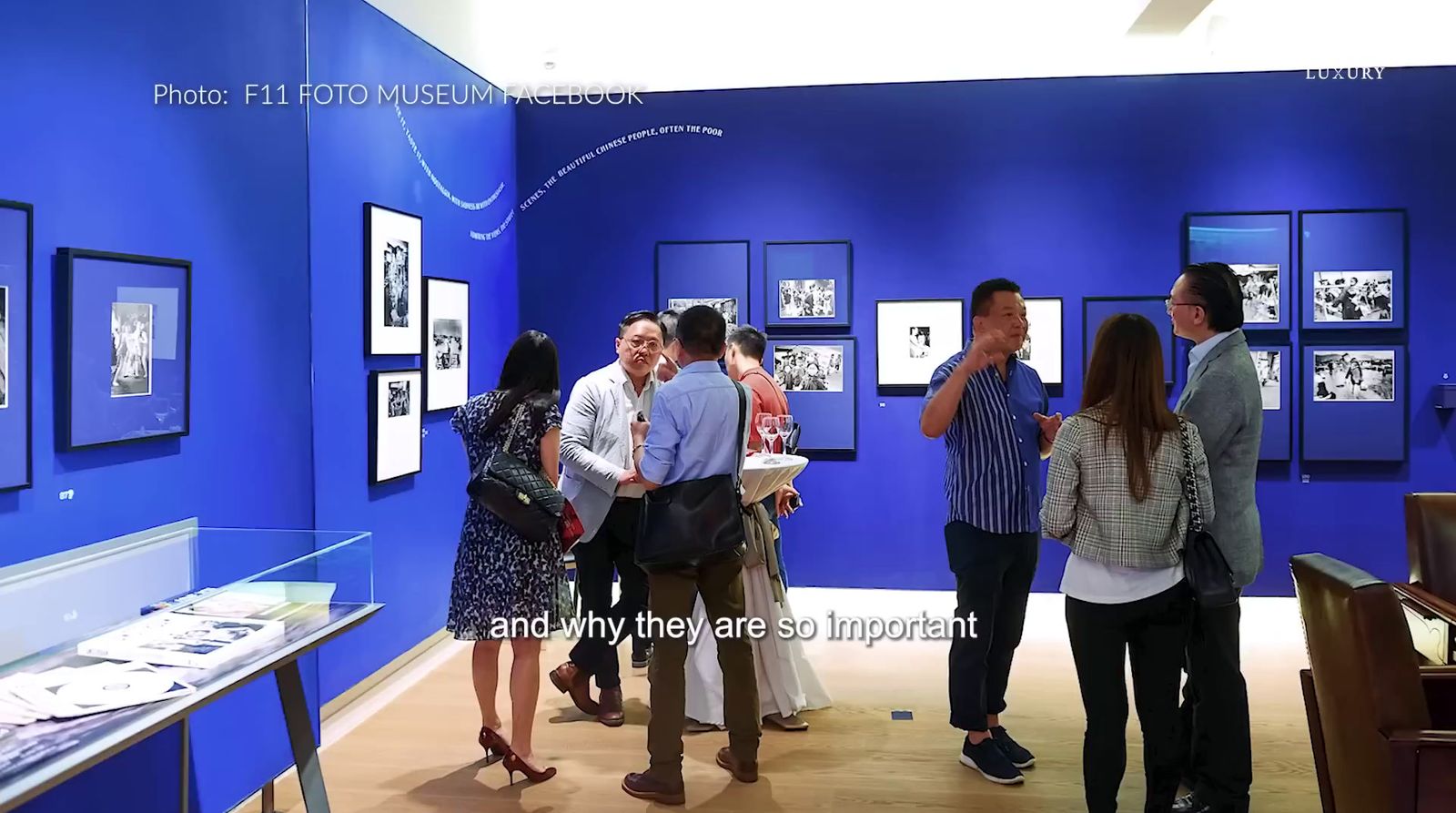 a group of people standing around a blue room