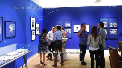 a group of people standing around a blue room