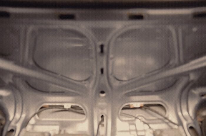 the inside of a car with the hood up