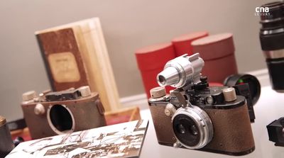 a couple of cameras sitting on top of a table