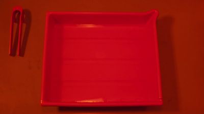 a red tray with a fork and spoon on a table