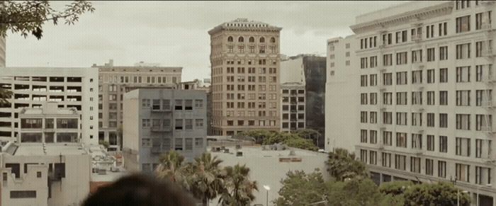 a person standing in front of a city with tall buildings