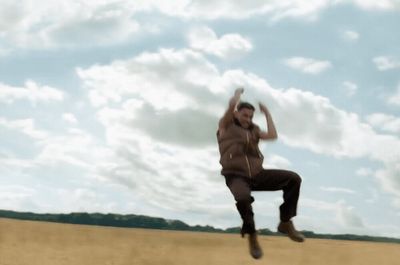 a man is jumping in the air in a field