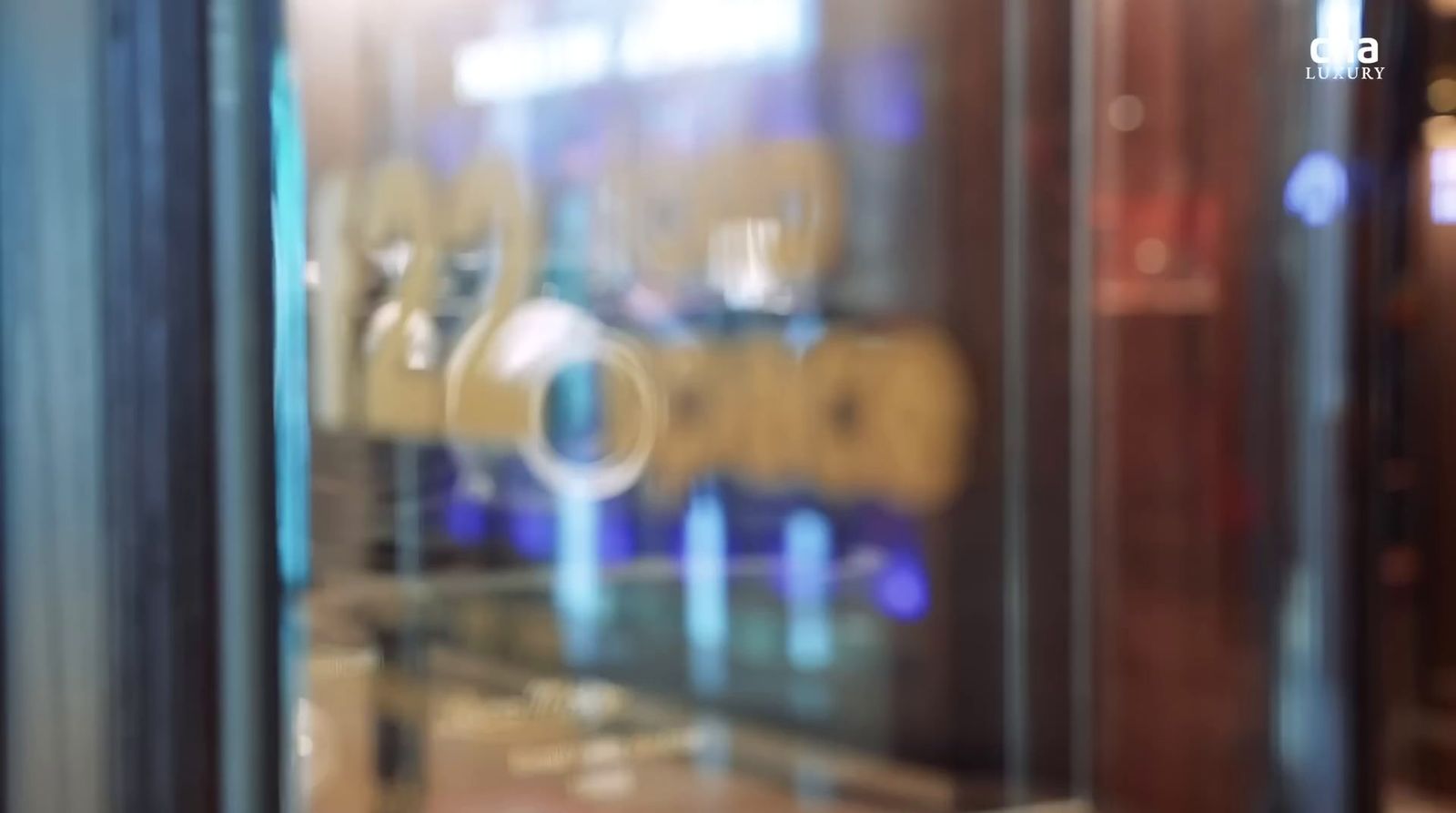 a close up of a glass door with a reflection of a building