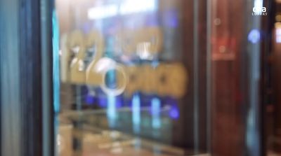 a close up of a glass door with a reflection of a building