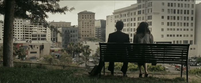 a man and a woman sitting on a bench