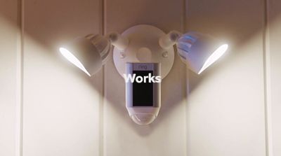 a wall mounted light with a work sign on it