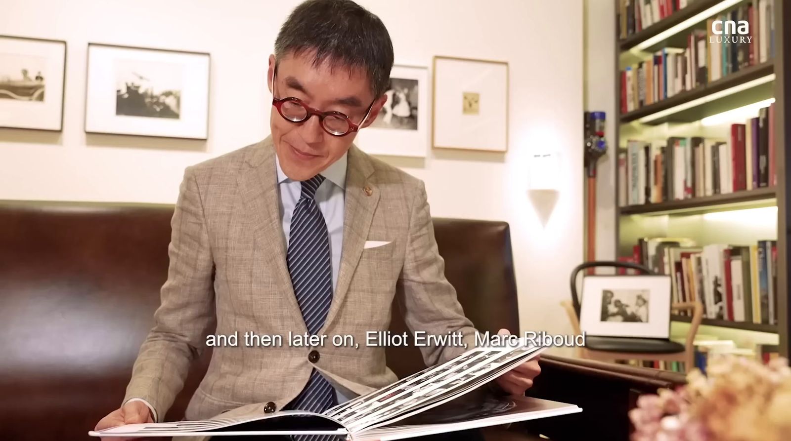 a man sitting in a chair reading a book