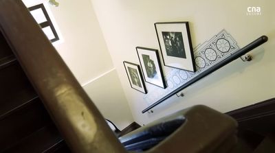 a stair case with pictures on the wall