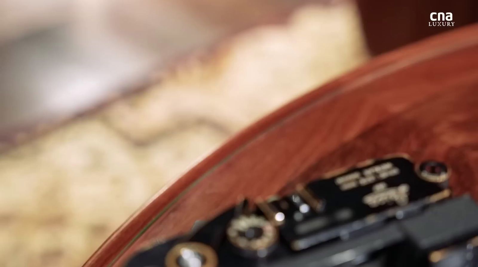 a close up of a clock on a wooden table