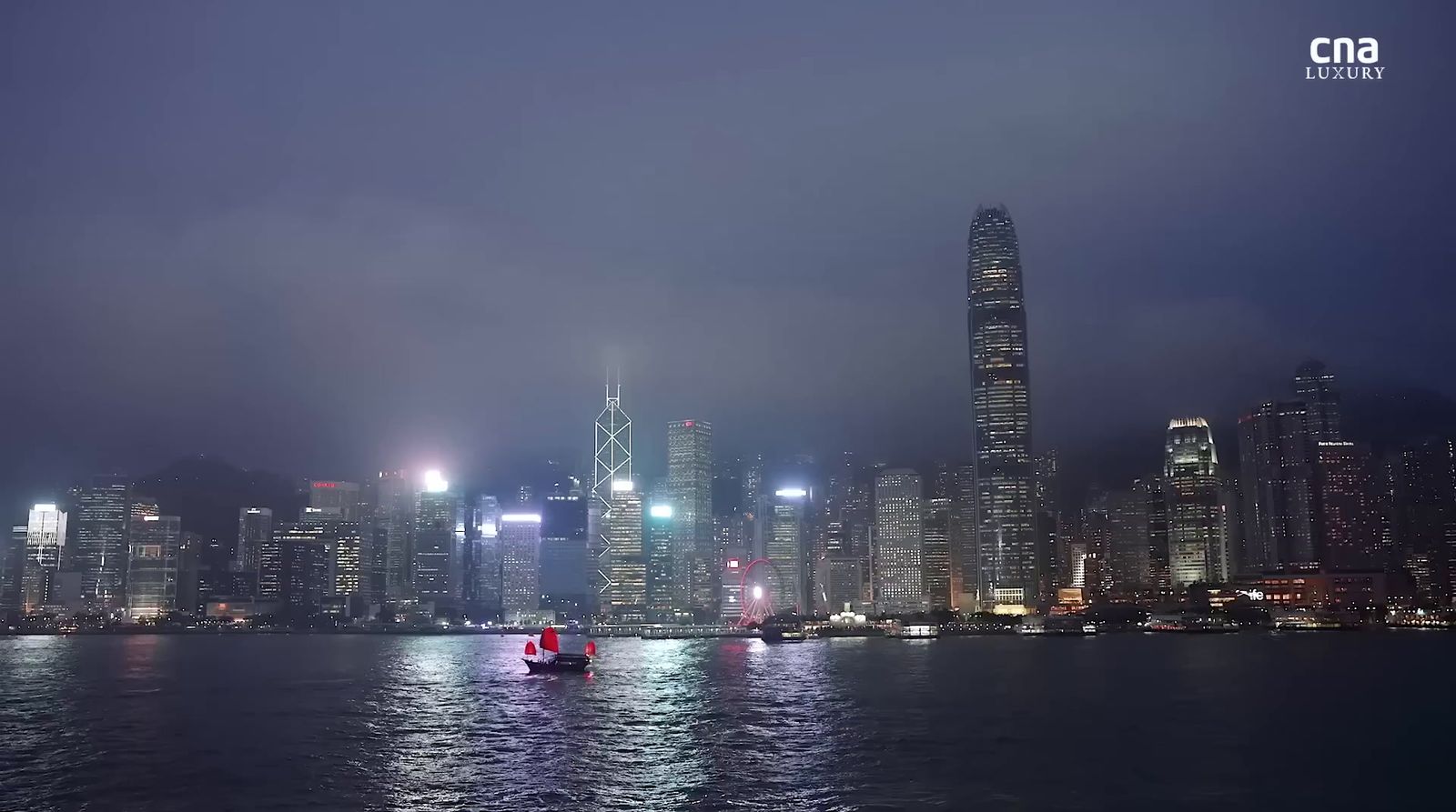 a boat in a body of water with a city in the background