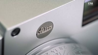 a close up of a clock on a metal surface