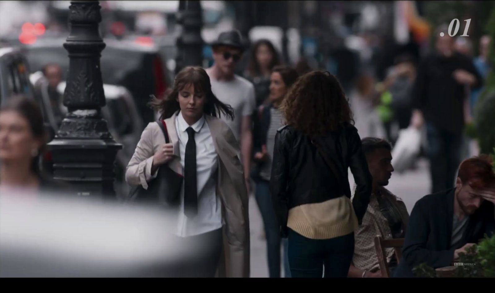 a group of people walking down a city street