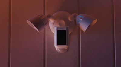 a cell phone mounted to a wall with two lamps