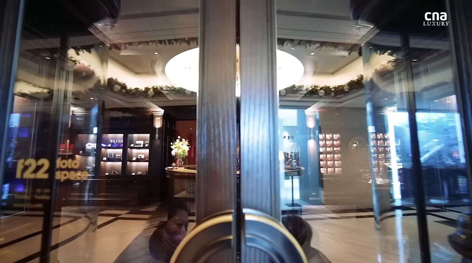 a store front with glass doors and a clock