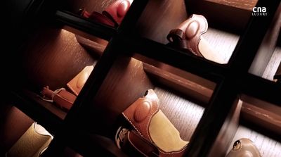 a row of wooden shelves filled with different types of shoes