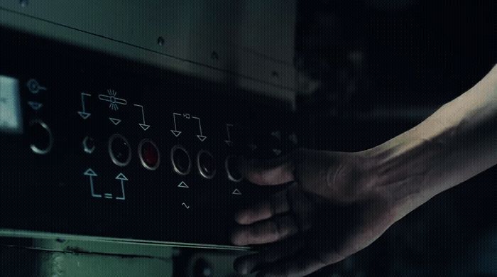 a person's hand reaching into an oven door