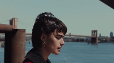 a woman standing next to a body of water