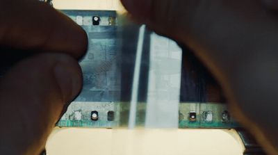 a close up of a person holding a piece of metal