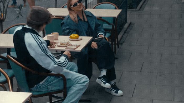 two people sitting at a table eating food