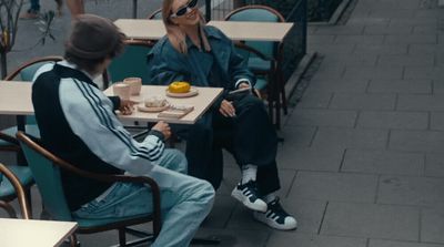 two people sitting at a table eating food