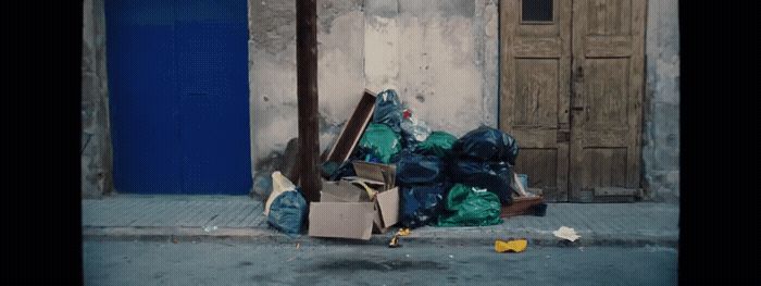 a pile of garbage sitting on the side of a road