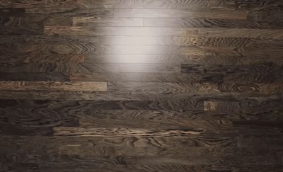 a light shines through a hole in a wood floor