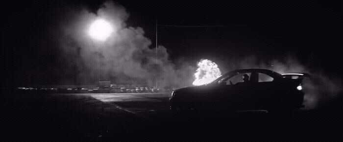 a black and white photo of a car on a street