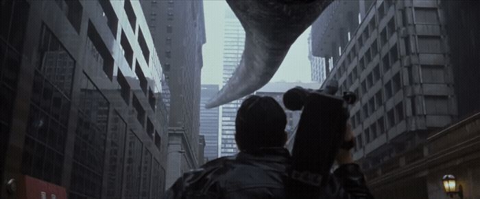 a man holding an umbrella walking down a city street