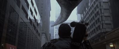 a man holding an umbrella walking down a city street