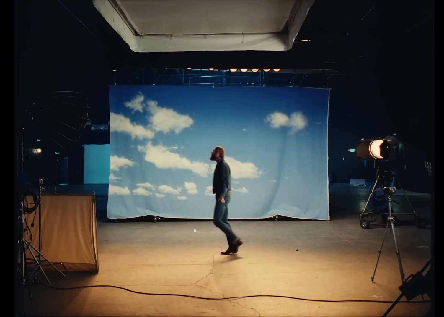 a man standing in front of a blue backdrop