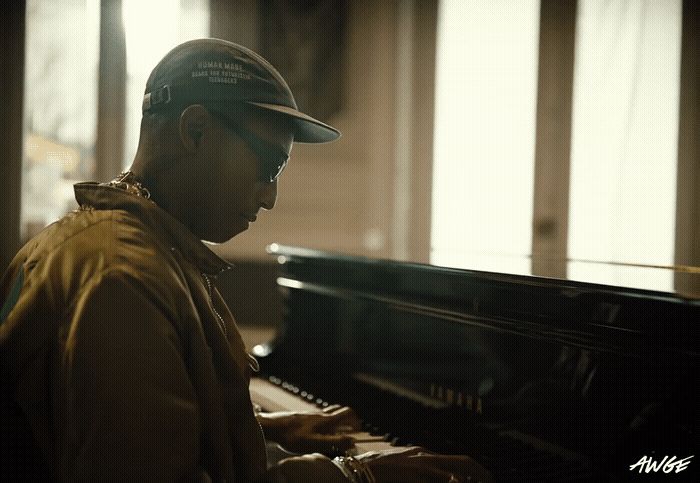 a man sitting at a piano in a room