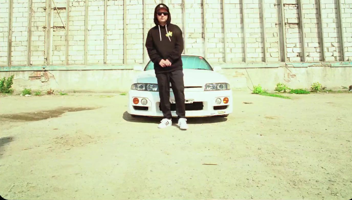 a man standing in front of a white car