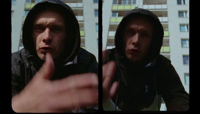 a man in a hooded jacket pointing at something