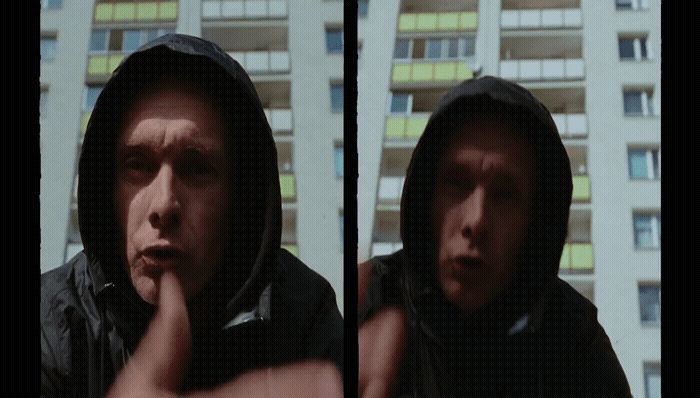 a man in a hooded jacket making a face