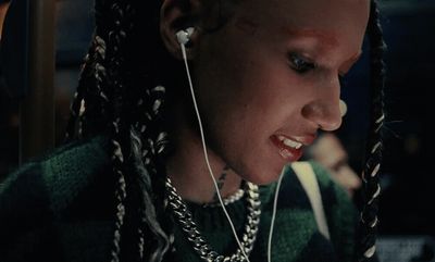 a woman with dreadlocks and ear buds on her ear