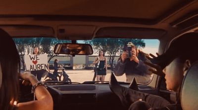 a group of people sitting in the back of a car