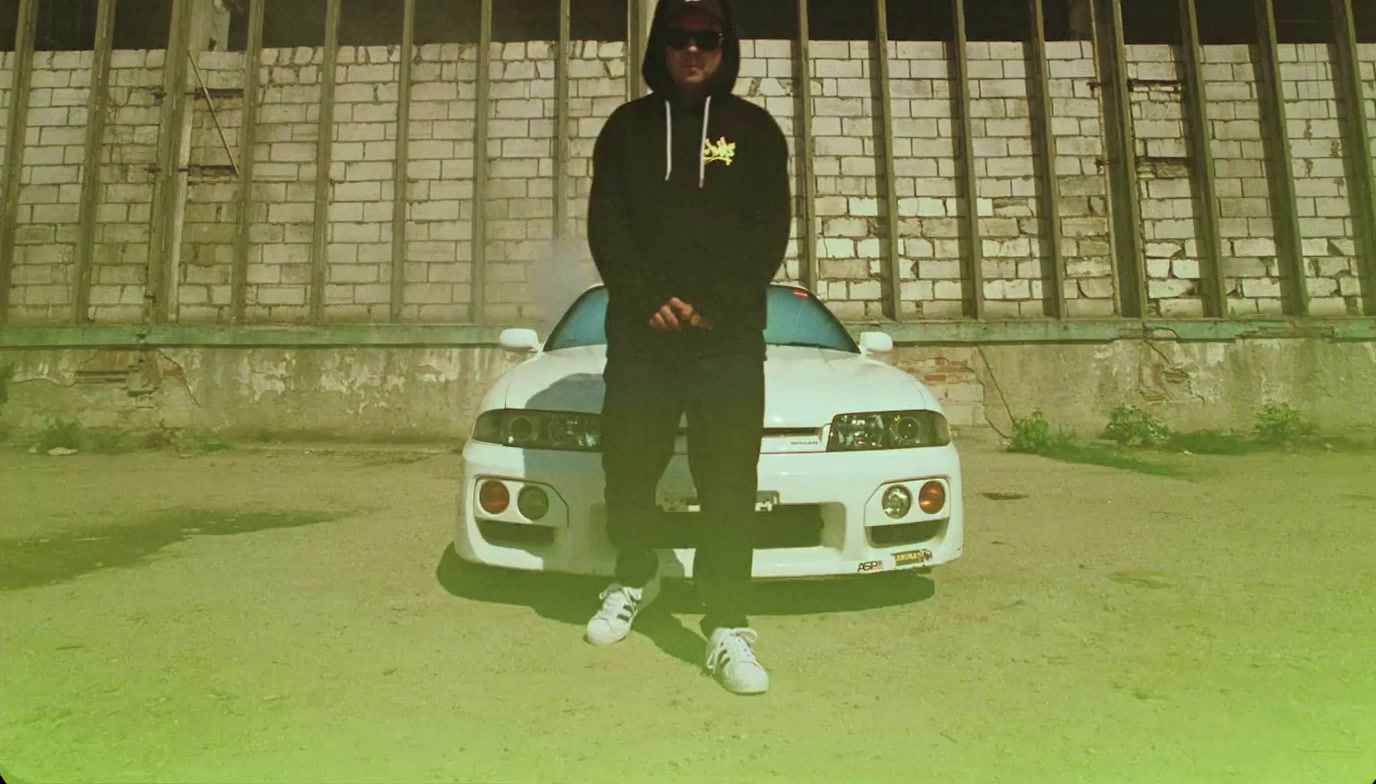 a man sitting on top of a white car