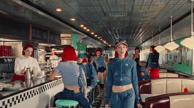 a group of women standing in a kitchen next to each other