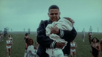 a man holding a baby in front of a group of people