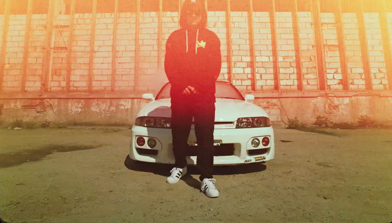 a man standing next to a white car