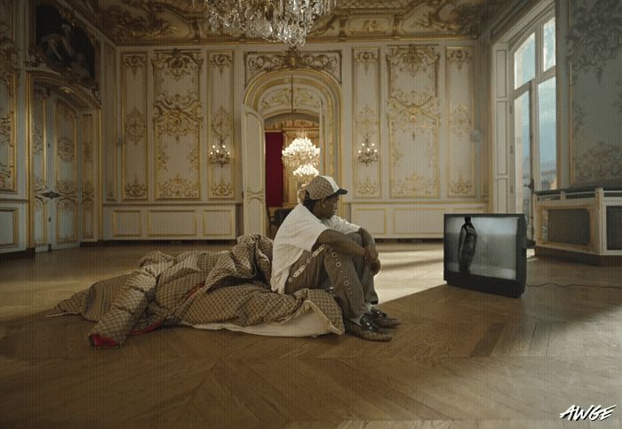 a man sitting on the floor in front of a tv