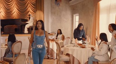 a group of women sitting around a table eating food