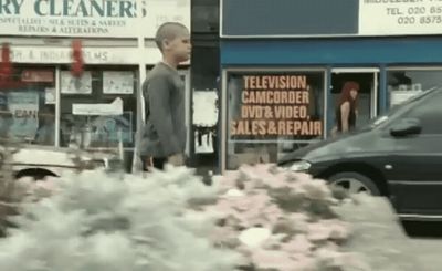 a car parked in front of a store with smoke coming out of it